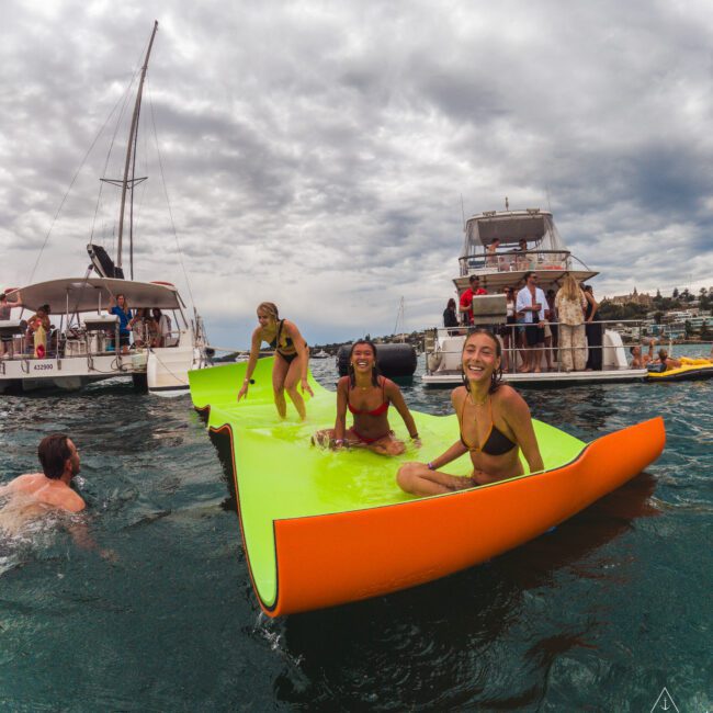 A group of people on a floating platform in water.