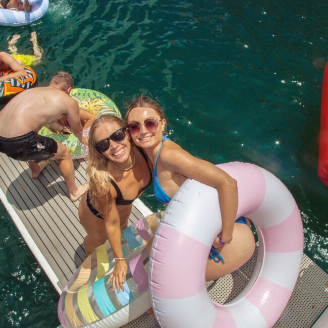 A group of women on a floating dock.