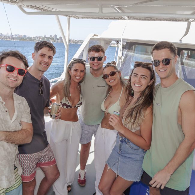 A group of people posing for a photo on a boat.