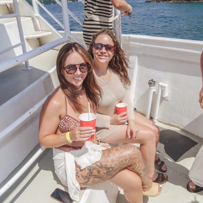 Two women sitting on a boat.