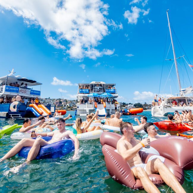 A group of people floating on rafts in water.